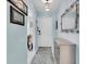 Bright hallway featuring soft blue walls, elegant decor, and a welcoming entrance to the home at 601 N Hercules Ave # 101, Clearwater, FL 33765