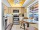 Eat-in kitchen featuring stainless steel appliances, wooden cabinets, and a sunlit breakfast nook at 601 N Hercules Ave # 101, Clearwater, FL 33765