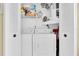 Convenient laundry area featuring a washer and dryer with shelving for storage at 601 N Hercules Ave # 101, Clearwater, FL 33765
