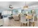 Open living area with modern furniture, light hardwood floors, and dining table at 601 N Hercules Ave # 101, Clearwater, FL 33765