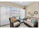 Cozy sunroom with wicker furniture, decorative mirrors, and bright natural light at 601 N Hercules Ave # 101, Clearwater, FL 33765