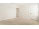 Carpeted bedroom with white walls, a closet, and a doorway to a closet at 6967 Silverado Ranch Blvd, Zephyrhills, FL 33541