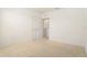 Bedroom with neutral carpet, white walls, bi-fold closet door and an entry to a closet at 6967 Silverado Ranch Blvd, Zephyrhills, FL 33541