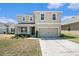 Charming two-story home with a two car garage and well-maintained front lawn at 6967 Silverado Ranch Blvd, Zephyrhills, FL 33541