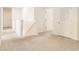 Hallway features neutral carpet and white walls leading to various rooms with doors at 6967 Silverado Ranch Blvd, Zephyrhills, FL 33541