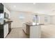 Well-lit kitchen with stainless steel sink, granite countertops, and black appliances at 6967 Silverado Ranch Blvd, Zephyrhills, FL 33541