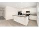 Modern kitchen featuring a central island, granite countertops, and sleek black appliances at 6967 Silverado Ranch Blvd, Zephyrhills, FL 33541