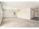 Spacious living room with light-colored walls and carpet flooring, naturally lit by a window at 6967 Silverado Ranch Blvd, Zephyrhills, FL 33541