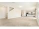 Open floor plan seamlessly connects the living area to the kitchen with modern appliances at 6967 Silverado Ranch Blvd, Zephyrhills, FL 33541
