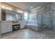 This bathroom offers a tub, a stylish vanity with double sinks, and a glass enclosed shower at 712 Estates Blvd, Tarpon Springs, FL 34689