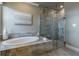 A luxurious bathroom features a soaking tub and a modern glass-enclosed shower at 712 Estates Blvd, Tarpon Springs, FL 34689