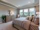This spacious bedroom features large windows, tray ceiling, and an elegant dresser at 712 Estates Blvd, Tarpon Springs, FL 34689
