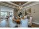 Dining room featuring a wood table, upholstered chairs, and an elegant modern chandelier at 712 Estates Blvd, Tarpon Springs, FL 34689