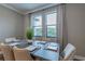Bright dining room with neutral tones and a clear view of the backyard through the windows at 712 Estates Blvd, Tarpon Springs, FL 34689