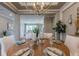 Dining room with a wood table, elegant decor, and access to other living spaces at 712 Estates Blvd, Tarpon Springs, FL 34689
