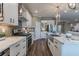 Gourmet kitchen featuring stainless steel appliances, modern fixtures, and seamless flow to the living area at 712 Estates Blvd, Tarpon Springs, FL 34689