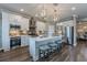 Kitchen island offers seating, stainless appliances, ample storage, and stylish pendant lighting at 712 Estates Blvd, Tarpon Springs, FL 34689