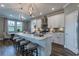 This kitchen features an island with counter seating, stainless appliances, and modern pendant lighting at 712 Estates Blvd, Tarpon Springs, FL 34689