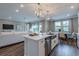 Stylish kitchen features a large island, stainless steel appliances, and seamless access to the living and dining areas at 712 Estates Blvd, Tarpon Springs, FL 34689