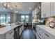 Bright kitchen features stainless appliances, white cabinetry, a large island, and modern lighting at 712 Estates Blvd, Tarpon Springs, FL 34689