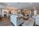 Open-concept living room showcases modern decor, neutral tones, and seamless flow to the kitchen and dining area at 712 Estates Blvd, Tarpon Springs, FL 34689