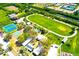 This stunning aerial view showcases community recreation area with sports courts and a running track at 732 Kingston Ct, Apollo Beach, FL 33572