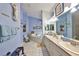 This serene bathroom features a double sink vanity, soaking tub, tile flooring and soft blue accents at 732 Kingston Ct, Apollo Beach, FL 33572