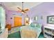 Charming bedroom with decorative rug, light purple walls, ceiling fan and lots of natural light at 732 Kingston Ct, Apollo Beach, FL 33572
