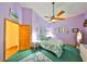 This bedroom features a ceiling fan, a side table, a full sized bed, and an ensuite bathroom at 732 Kingston Ct, Apollo Beach, FL 33572