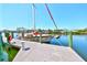 A boat is docked on a well-maintained wooden dock, offering convenient waterfront access and scenic views at 732 Kingston Ct, Apollo Beach, FL 33572