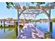 Beautiful waterfront home featuring a private dock with a pergola and access to the open water at 732 Kingston Ct, Apollo Beach, FL 33572