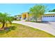 Attractive home exterior featuring a covered porch, lush landscaping, and a driveway leading to an attached garage at 732 Kingston Ct, Apollo Beach, FL 33572