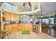 Bright kitchen with wood cabinets, tile floors, and views to the dining room at 732 Kingston Ct, Apollo Beach, FL 33572