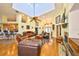Spacious living room with high ceilings, skylights, hardwood floors, a fireplace, and comfortable leather furniture at 732 Kingston Ct, Apollo Beach, FL 33572
