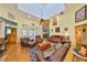 Bright and spacious living room featuring high ceilings, skylights, hardwood floors, and comfortable seating arrangements at 732 Kingston Ct, Apollo Beach, FL 33572
