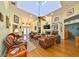 Bright and airy living room featuring hardwood floors, a fireplace, comfortable seating, and abundant natural light at 732 Kingston Ct, Apollo Beach, FL 33572