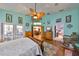 Bright main bedroom features hardwood floors, a decorative ceiling fan, and access to an ensuite bathroom and outdoor patio at 732 Kingston Ct, Apollo Beach, FL 33572