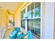 Charming front porch features a seating area with cushions, offering a relaxing space to enjoy the neighborhood views at 732 Kingston Ct, Apollo Beach, FL 33572
