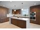 Modern kitchen boasts sleek cabinets, large island, and stainless steel appliances at 777 3Rd Ave N # 1403, St Petersburg, FL 33701