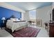 Comfortable primary bedroom with a plush bed, bright blue accent wall, and great natural light at 777 3Rd Ave N # 1403, St Petersburg, FL 33701