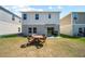 Back yard with outdoor seating on grass, sliding glass door to home at 7797 Peace Lily Ave, Wesley Chapel, FL 33545