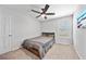 Bedroom featuring neutral paint, carpeted floor, and wood frame bed with storage underneath at 7797 Peace Lily Ave, Wesley Chapel, FL 33545