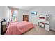 Bedroom with natural light featuring a bed, tv, vanity, and carpet flooring at 7797 Peace Lily Ave, Wesley Chapel, FL 33545
