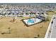 Aerial shot of neighborhood amenity showcasing a community pool, clubhouse, and playground in a landscaped setting at 7797 Peace Lily Ave, Wesley Chapel, FL 33545
