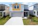 Two-story home with an attached garage, neutral colors and a well-maintained lawn at 7797 Peace Lily Ave, Wesley Chapel, FL 33545