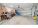 Spacious two car garage with some items. Door is white with horizontal designs at 7797 Peace Lily Ave, Wesley Chapel, FL 33545