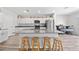 The bright kitchen has a large center island with barstool seating and stainless steel appliances at 7797 Peace Lily Ave, Wesley Chapel, FL 33545