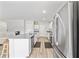 Bright kitchen features stainless steel appliances, a center island, and white cabinetry at 7797 Peace Lily Ave, Wesley Chapel, FL 33545