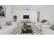 Bright living room features modern decor, neutral tones, and stylish furniture at 7797 Peace Lily Ave, Wesley Chapel, FL 33545