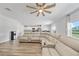 Open-concept living room with plush seating and easy access to the kitchen at 7797 Peace Lily Ave, Wesley Chapel, FL 33545